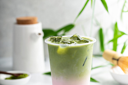 Cold matcha latte in a tall glass on marble, a Food & Drink Photo by farwasser