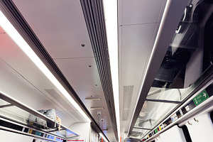 Interior of a modern train carriage with seating, luggage, and bright overhead, a Photo by AS photostudio