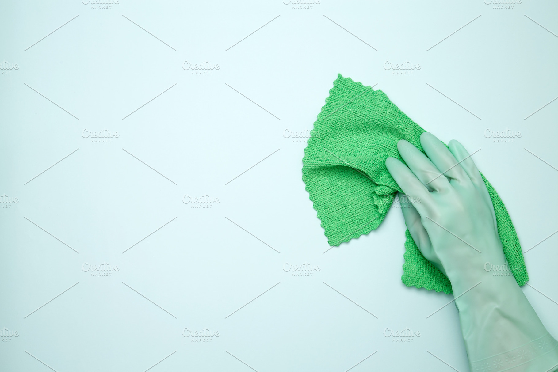 Womans hand in rubber glove holds cloths. House cleaning. Copy space, a Photo by matucha
