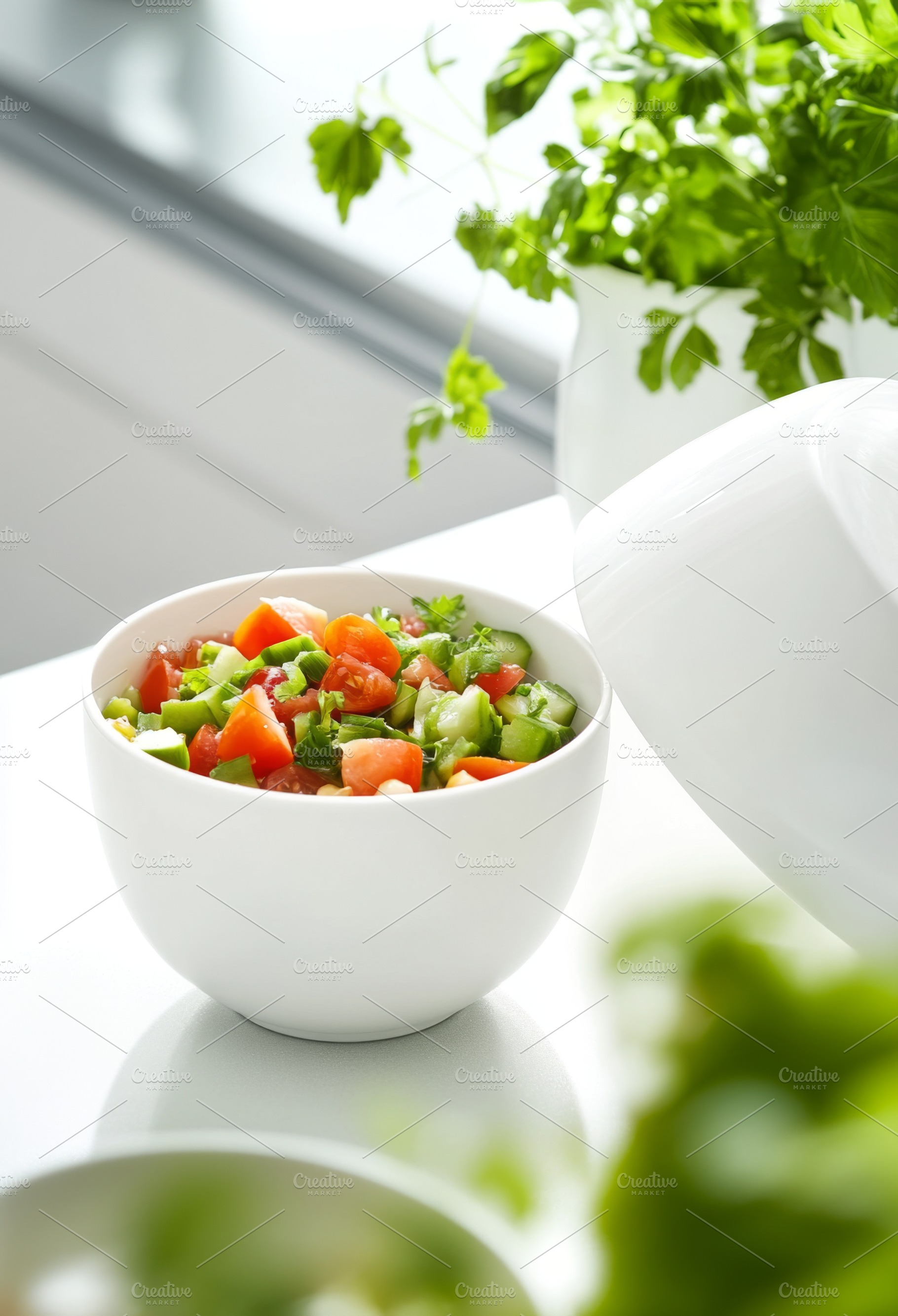 Fresh vegetable salad in a white bow, a Photo by Dvoevnore photos