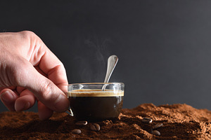 Hand holding cup with hot coffee on ground coffee, a Food & Drink Photo by Davizro's Market