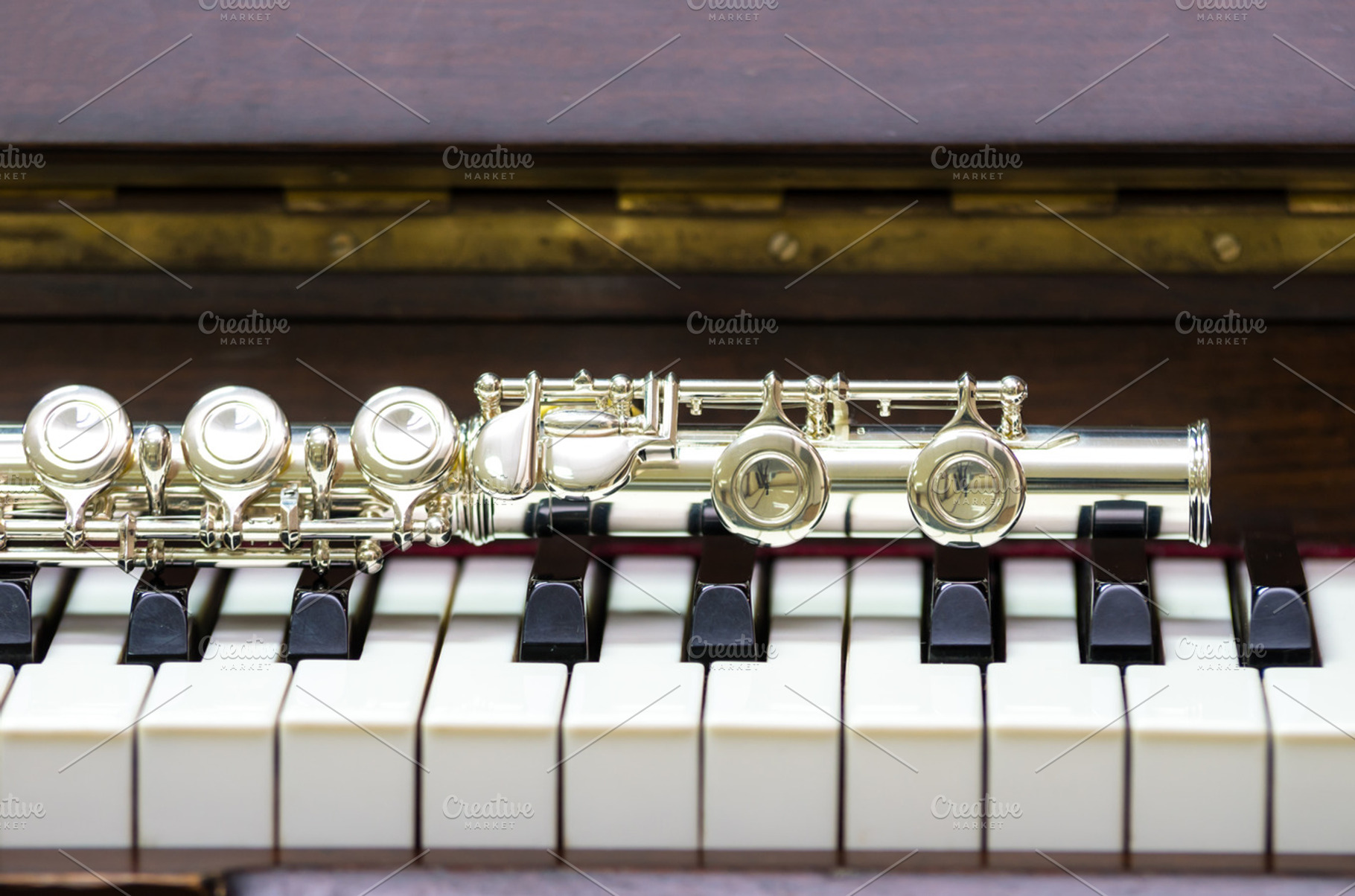 Closeup flute on the keyboard containing acoustic, boehm, and brass, an Arts & Entertainment Photo by Tzido Gallery