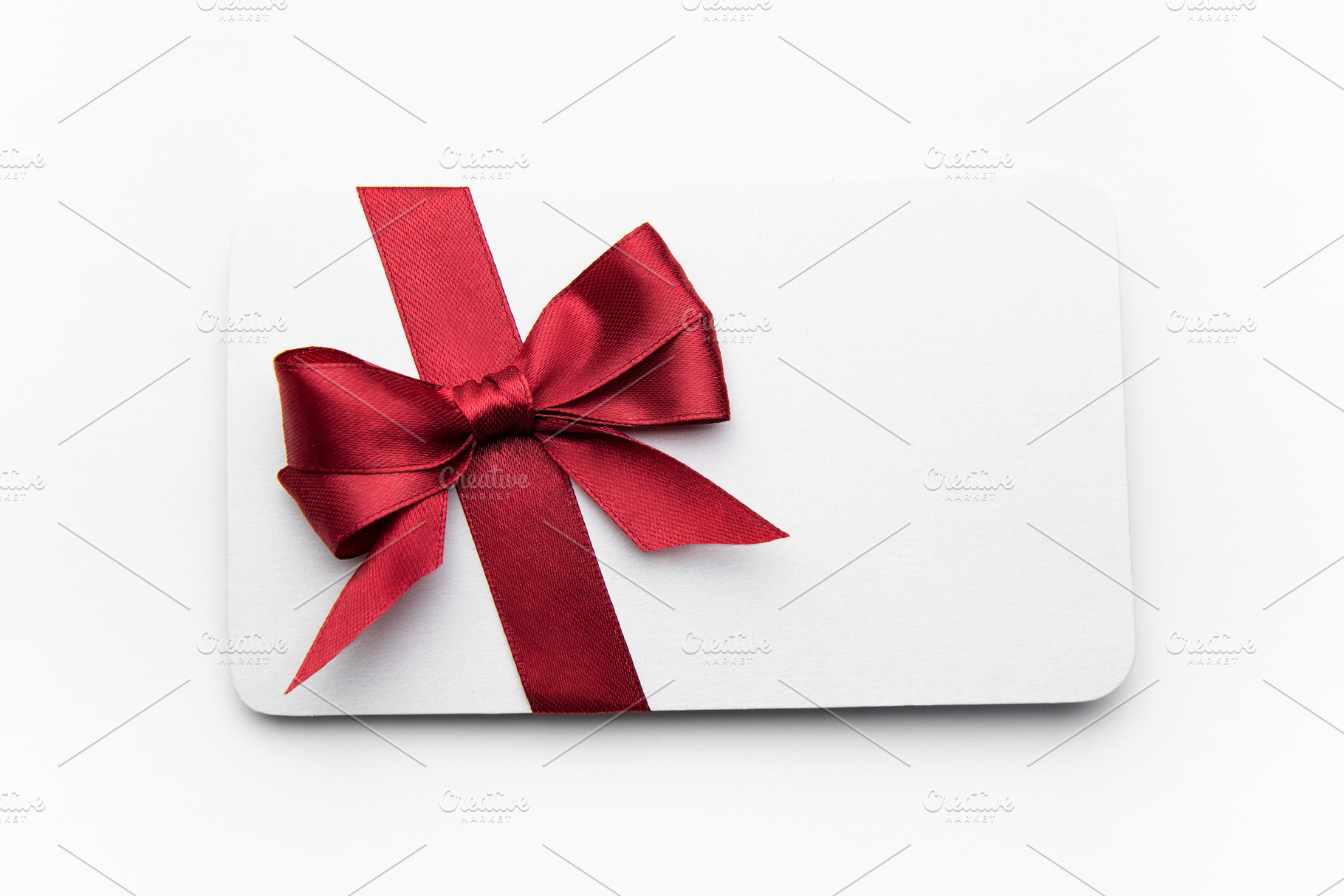 Blank gift card decorated with red ribbon bow, a Holiday Photo by Olena Rudo