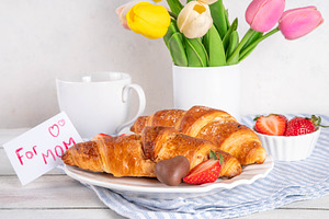 Mother’s Day breakfast background featuring croissant, strawberr, a Holiday Photo by Rimma