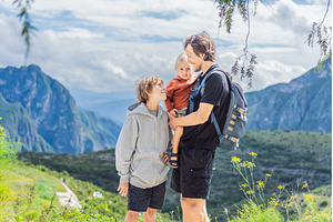 Father with his two sons standing in, a Holiday Photo by Elizaveta Galitskaya
