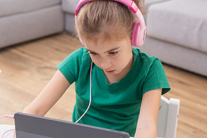 Young girl wearing headphones using tablet for online learning., a Person Photo by etorres69