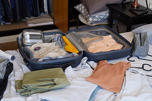 an open suitcase organized with travel clothes, a Photo by Nito
