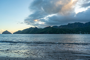 Taiohae Bay at sunset with sailboats in Nuku Hiva, Marquesas Isl, a Photo by GoodGoods