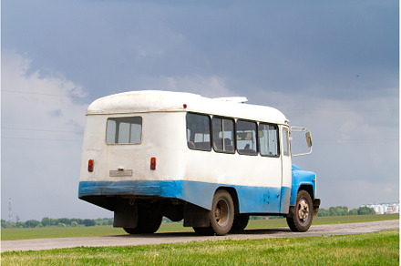 vintage bus driving on country road, a Transportation Photo by Pakosta