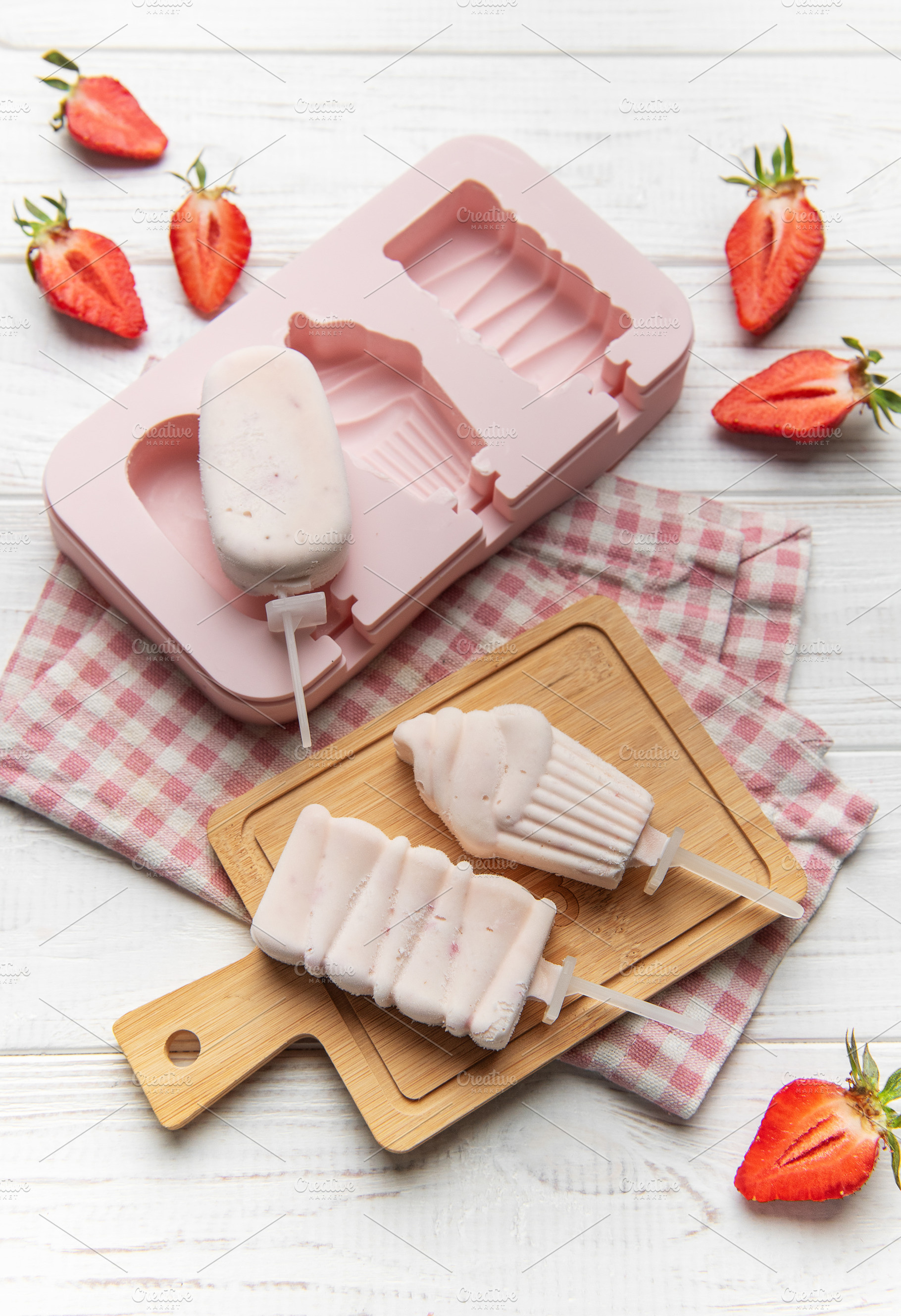 Making homemade strawberry ice pops with silicone mold, a Food & Drink Photo by Olena Rudo