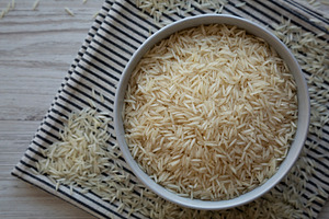 Uncooked White Organic Basmati Rice in a Bowl, top view. Close-u, a Food & Drink Photo by LiudmylaChuhunova