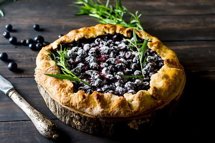 Homemade blackcurrant galette on old dark wooden  background., a Food & Drink Photo by vimart