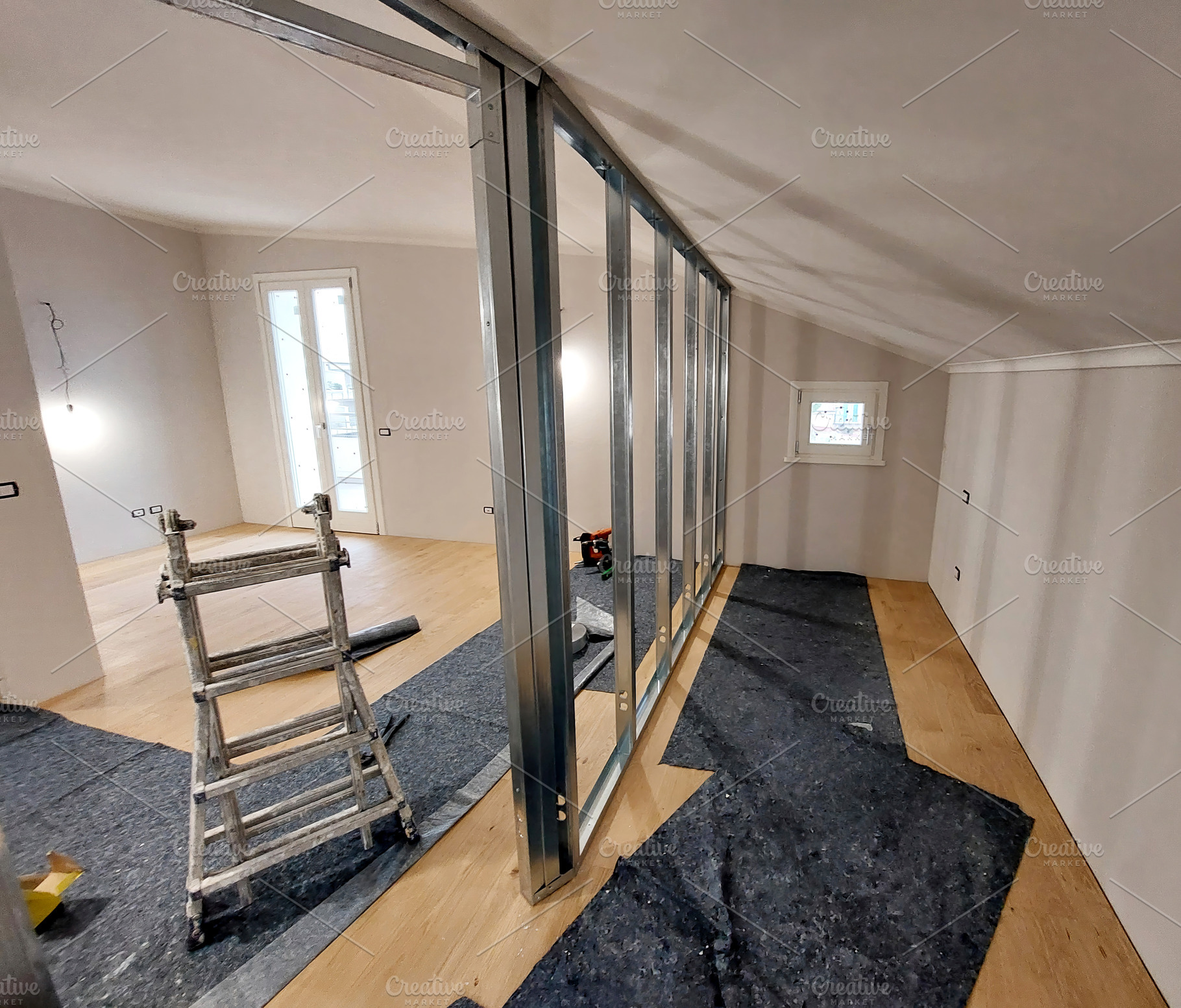Metal frame for plasterboard wall being assembled in an attic during renovation, an Architecture Photo by Antonio Gravante Market