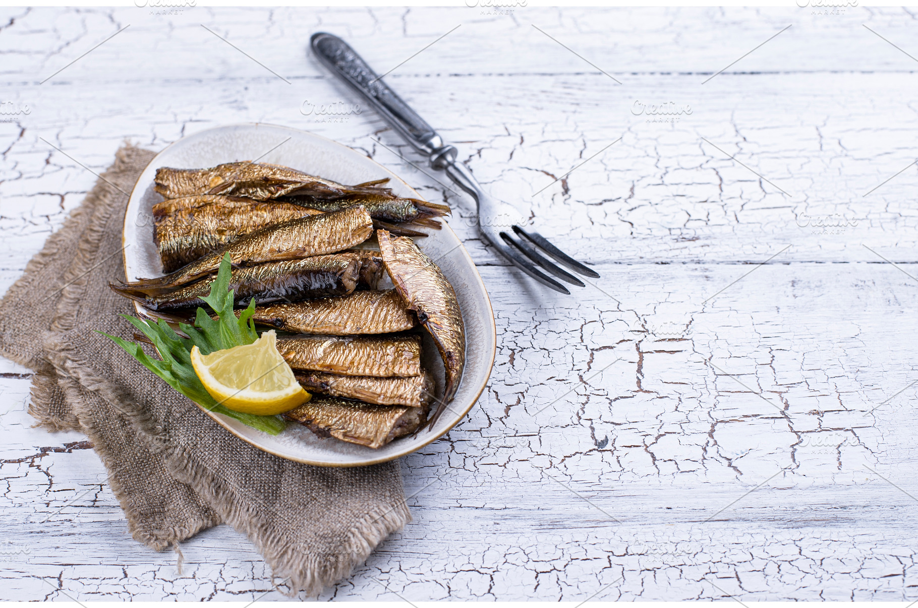 Canned smoked sprats in oil, a Food & Drink Photo by Yulia Furman