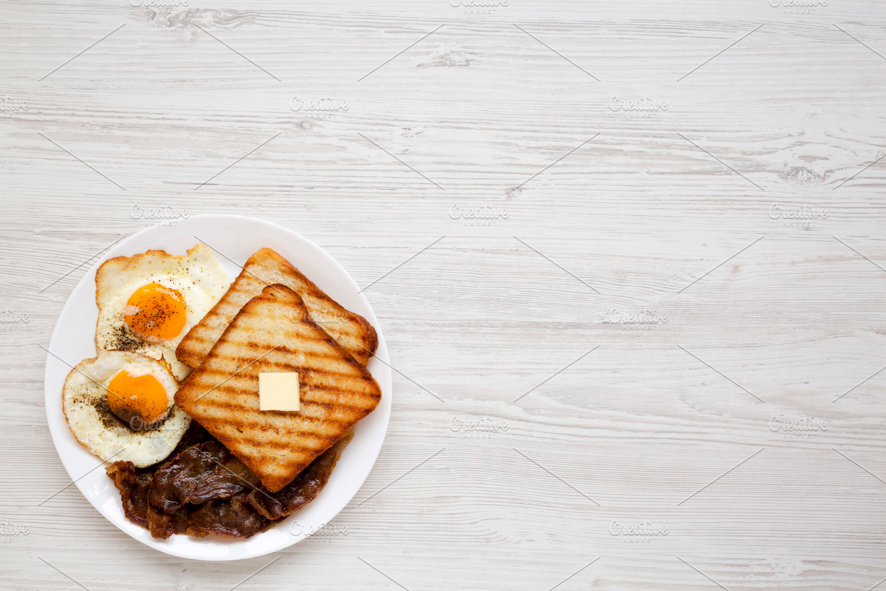 Homemade Healthy Sunnyside Eggs Breakfast on a white plate on a, a Food & Drink Photo by LiudmylaChuhunova