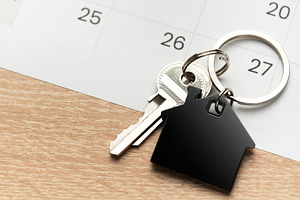 House key with keychain on calendar showing important date, a Business Photo by Olena Rudo