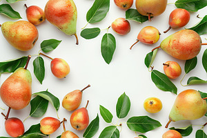 Red pears with leafs and copyspace for text on white background, a Food & Drink Photo by AlyaAnd