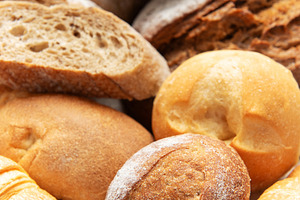 Assortment of fresh baked bread rolls and pastries, a Food & Drink Photo by Olena Rudo
