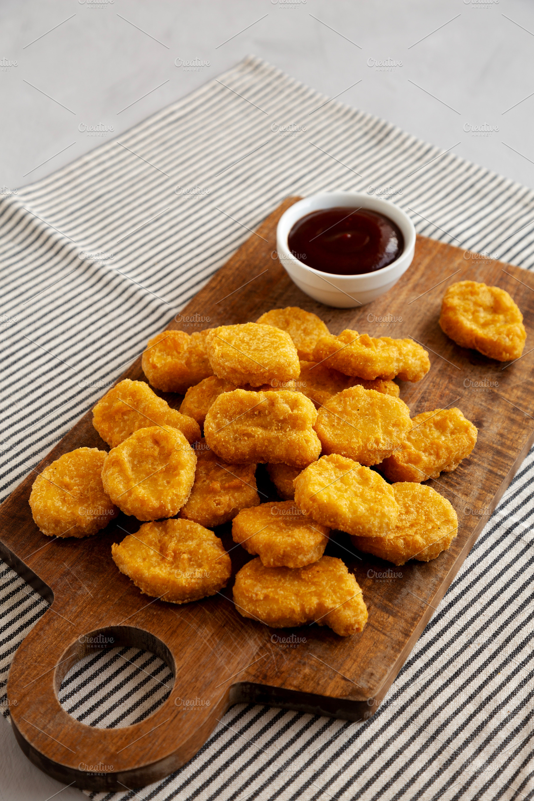 Organic Fried Chicken Nuggets on a wooden board, side view. Copy, a Food & Drink Photo by LiudmylaChuhunova