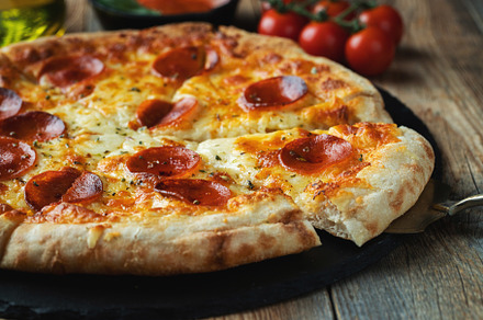 A slice of hot Italian pizza with stretching cheese. Pizza pepperoni on a dark, a Food & Drink Photo by Budarinphoto
