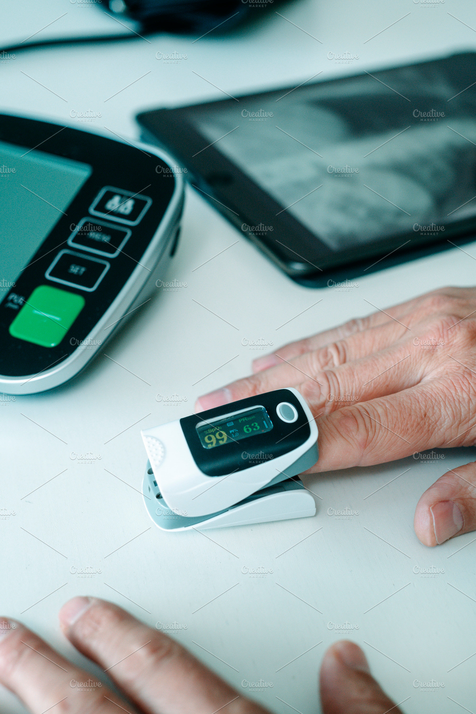 measuring oxygen saturation during a health check, a Photo by Nito