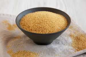 Organic Demerara Sugar in a Bowl, side view. Close-up., a Food & Drink Photo by LiudmylaChuhunova