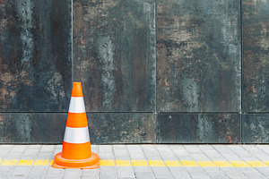 Plastic traffic cone against wall, a Transportation Photo by BOOCYS