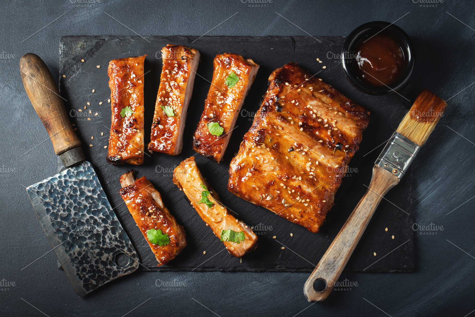 Barbecue pork spare ribs with hot honey chili marinade on black background, a Food & Drink Photo by Budarinphoto