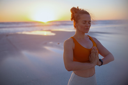fitness sports woman at beach at sunset meditating, a Sports & Recreation Photo by Alliance Images