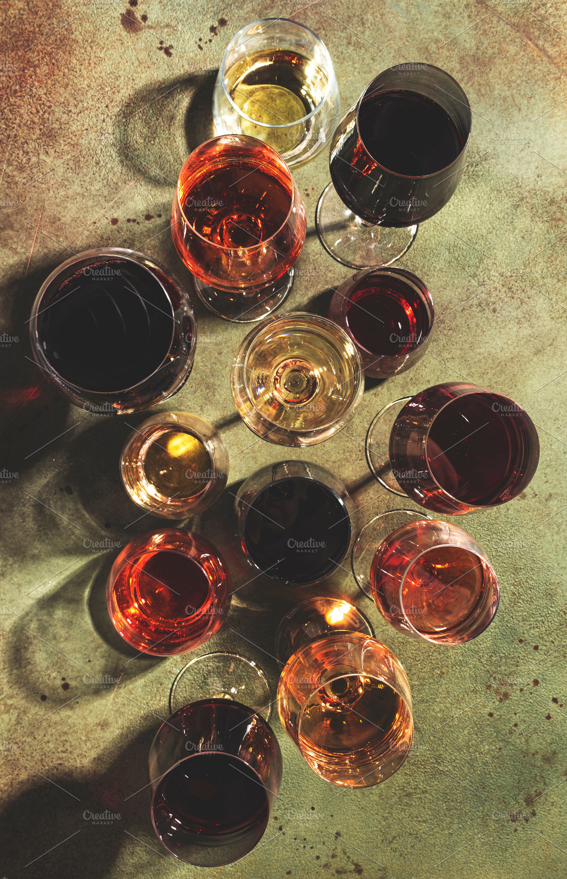 Red, white and rose wines in assortment in glasses on green back, a Food & Drink Photo by 5PH