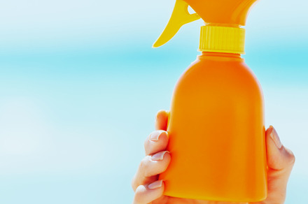 Closeup on bottle of sun screen creme in hand of woman, a Person Photo by Alliance Images