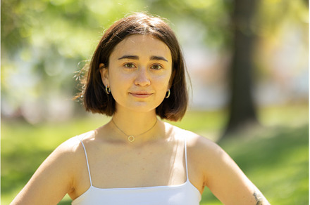 A woman with short hair and a white