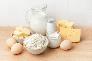Fresh dairy products and eggs on wooden table, a Food & Drink Photo by Olena Rudo