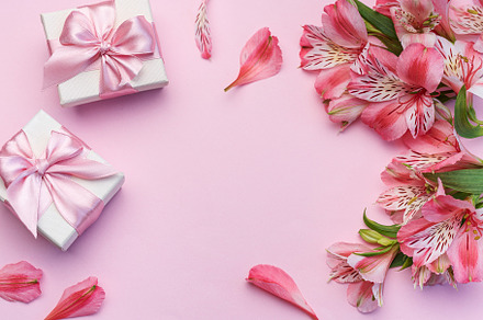 Beautiful Alstroemeria flowers and gift boxes on pink background, a Holiday Photo by Olena Rudo