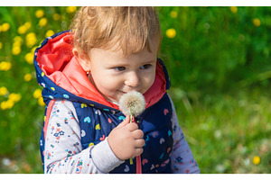 Child with dandelions in the garden, a Nature Photo by yanadjana