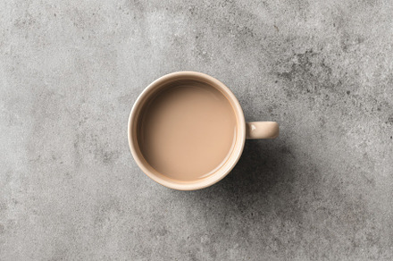 Beige ceramic mug on stone surface, a Food & Drink Photo by Virgo Studio