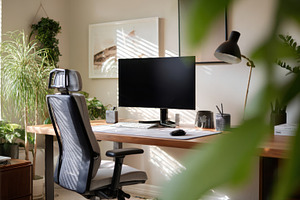Home office with computer and plants, a Photo by Beautiful things
