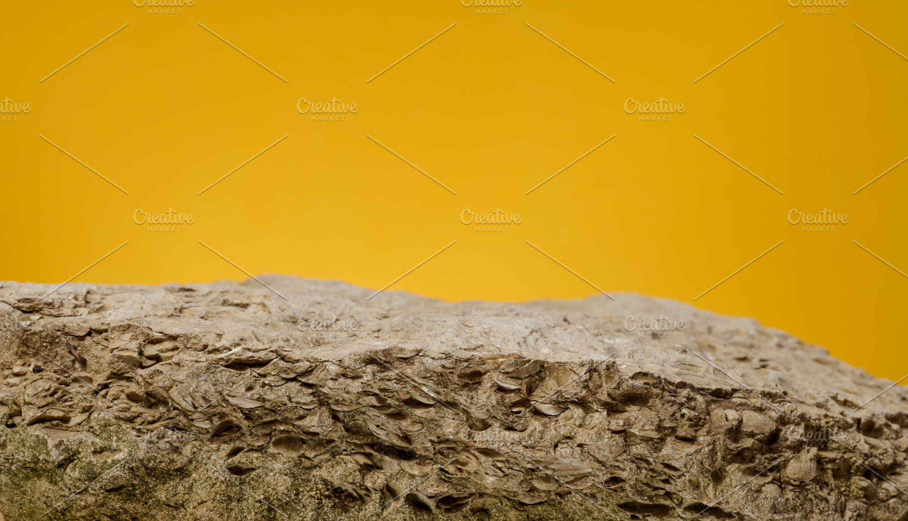 Stones on yellow background, stage for advertising and product d, a Background Photo by ndanko