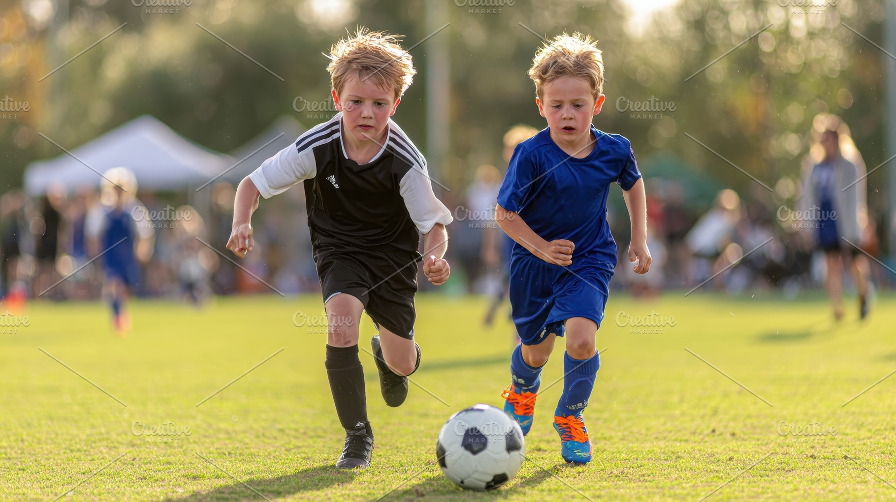 Young soccer players chase the ball, a Photo by Pixeness Studio