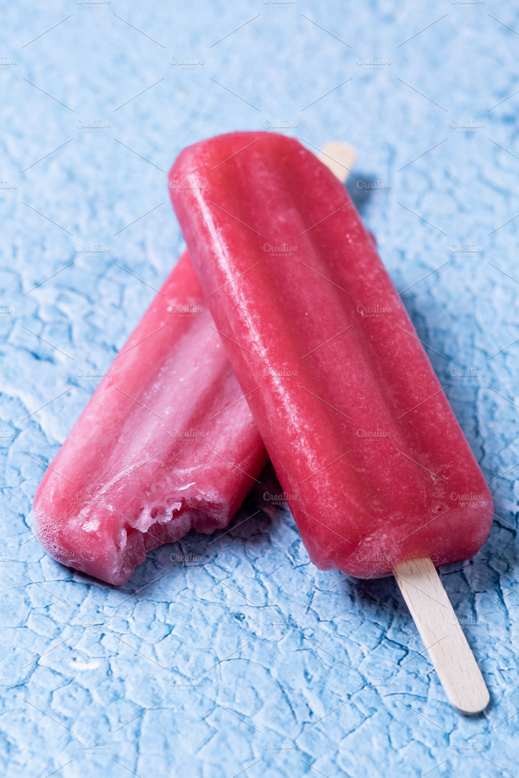 Red strawberry popsicles on blue bac, a Food & Drink Photo by etorres69