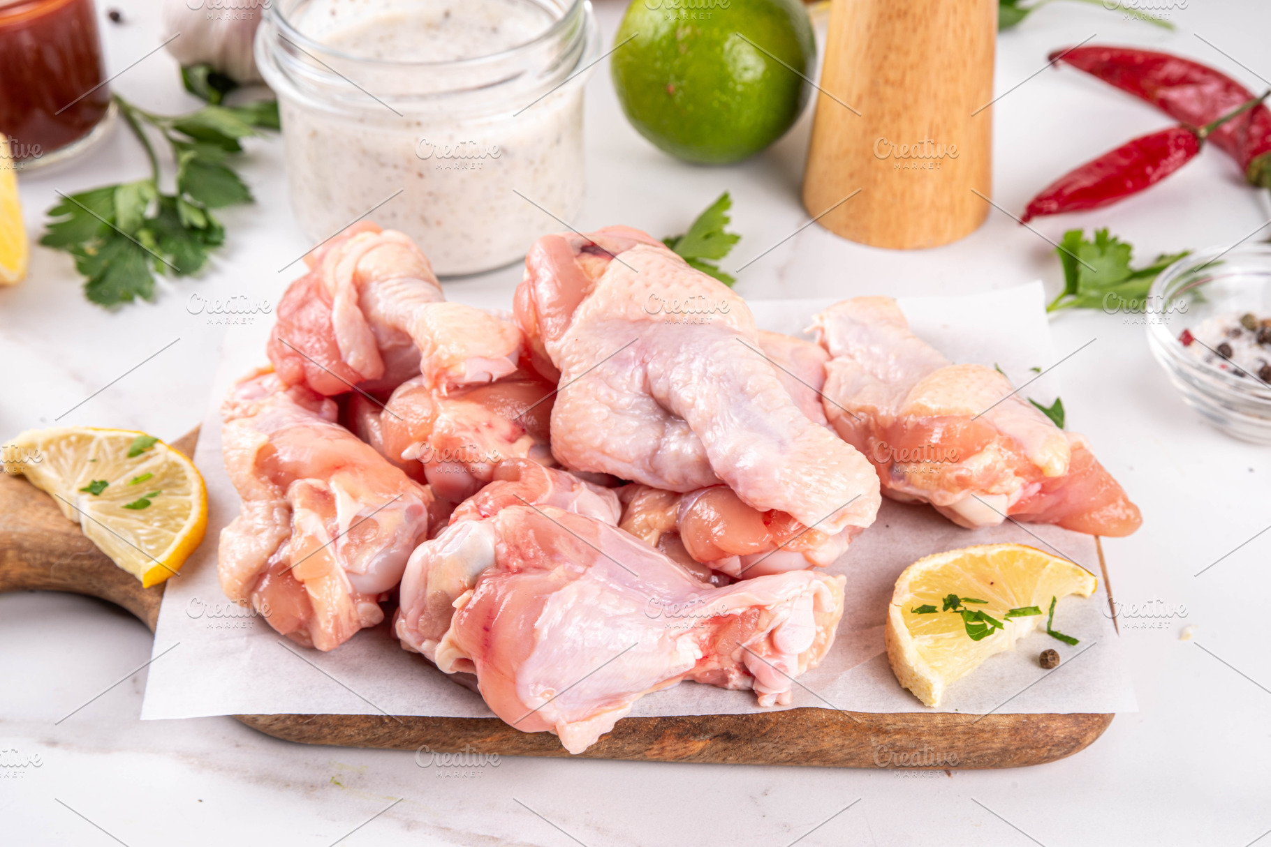 Fresh raw organic chicken wings, with spices and condiments, a Food & Drink Photo by Rimma