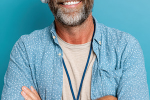 Smiling man with headphones on blue background, a Person Photo by AlyaAnd