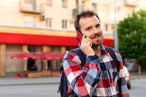 Smiling young man talking on phone, a Person Photo by Elena Vagengeim