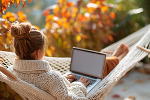 Woman relaxing on hammock with laptop during autumn afternoon in a cozy environ, a Person Photo by AlyaAnd