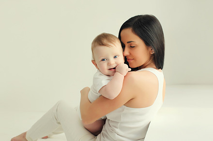 Happy young mother holding cute baby, a Person Photo by Rohappy