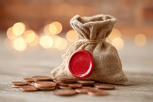 Burlap sack with copper coins and heart button, a Business Photo by AlyaAnd