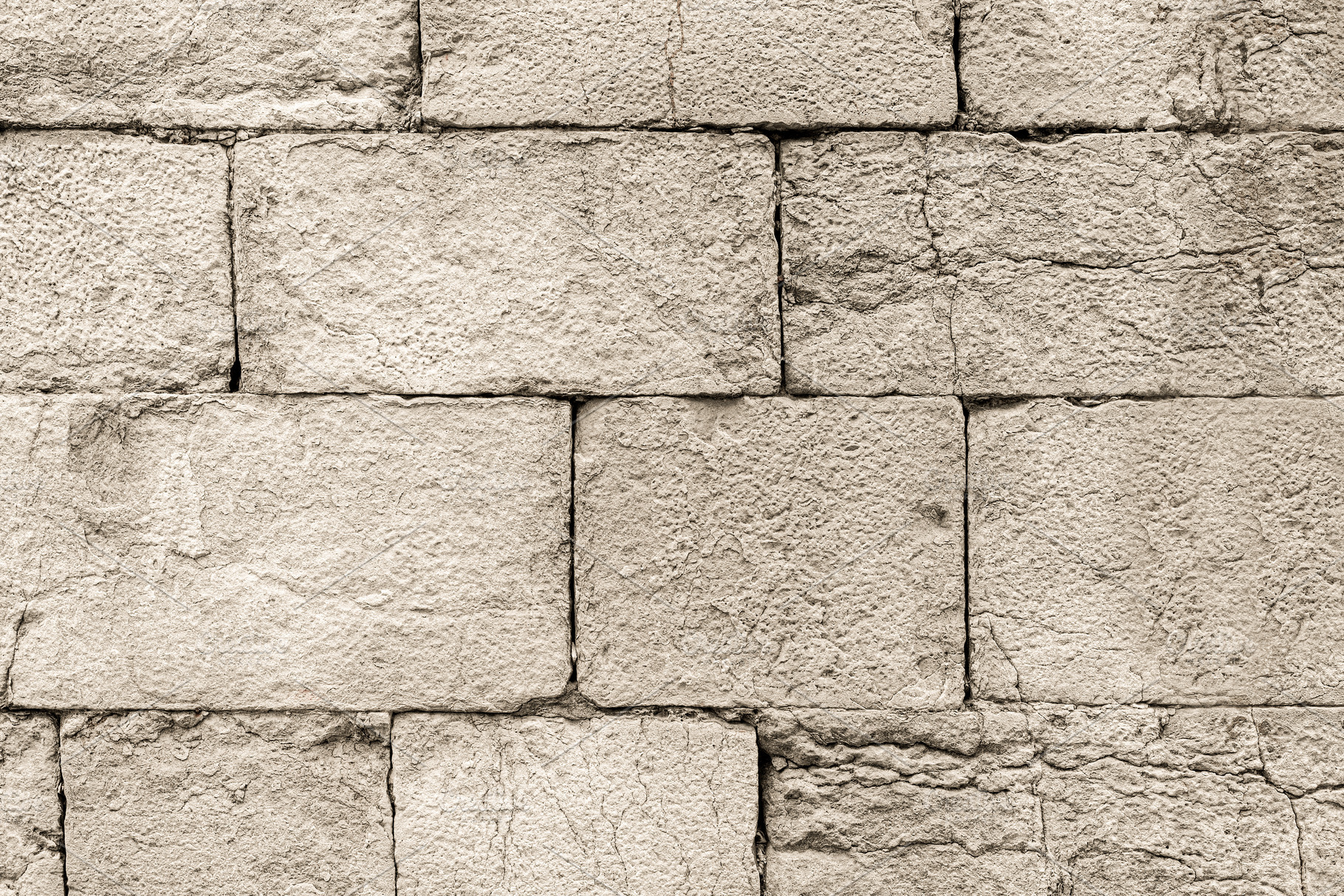 Old gray cracked stone brick wall outside, a Holiday Photo by Iván Moreno STOCK PHOTO