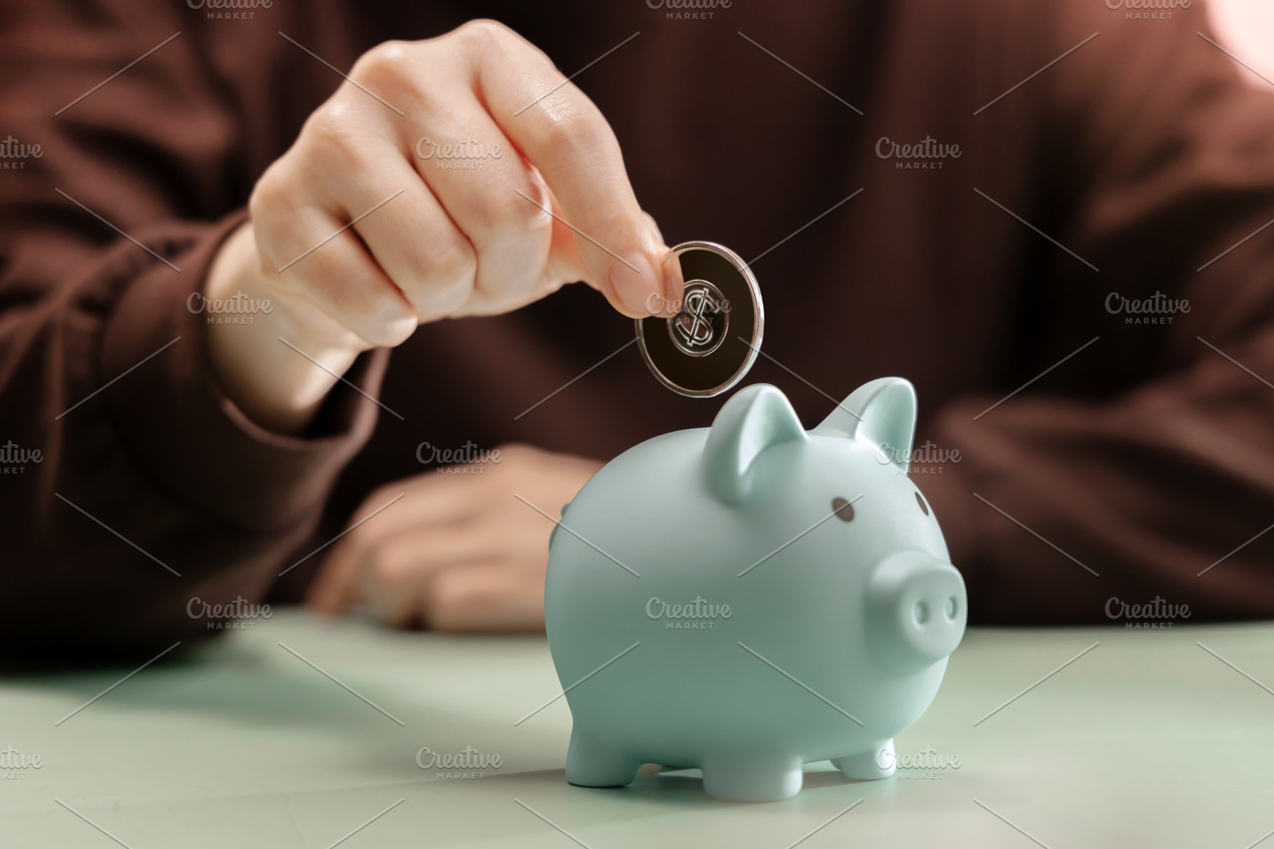 Hand dropping Coin into Piggy bank. Saving money, financial disc, a Photo by salmon.black