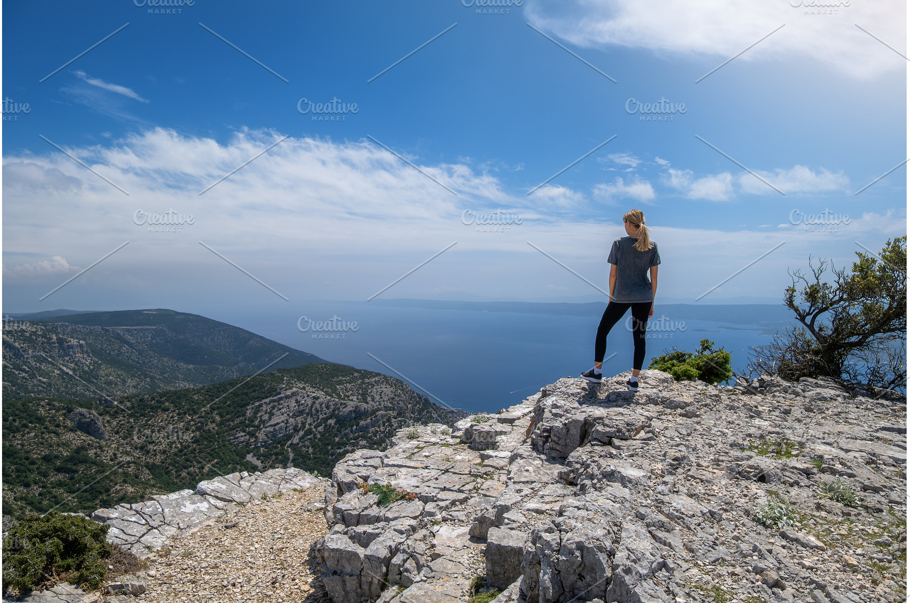 Young woman hiking on a cliff and, a Person Photo by den-belitsky