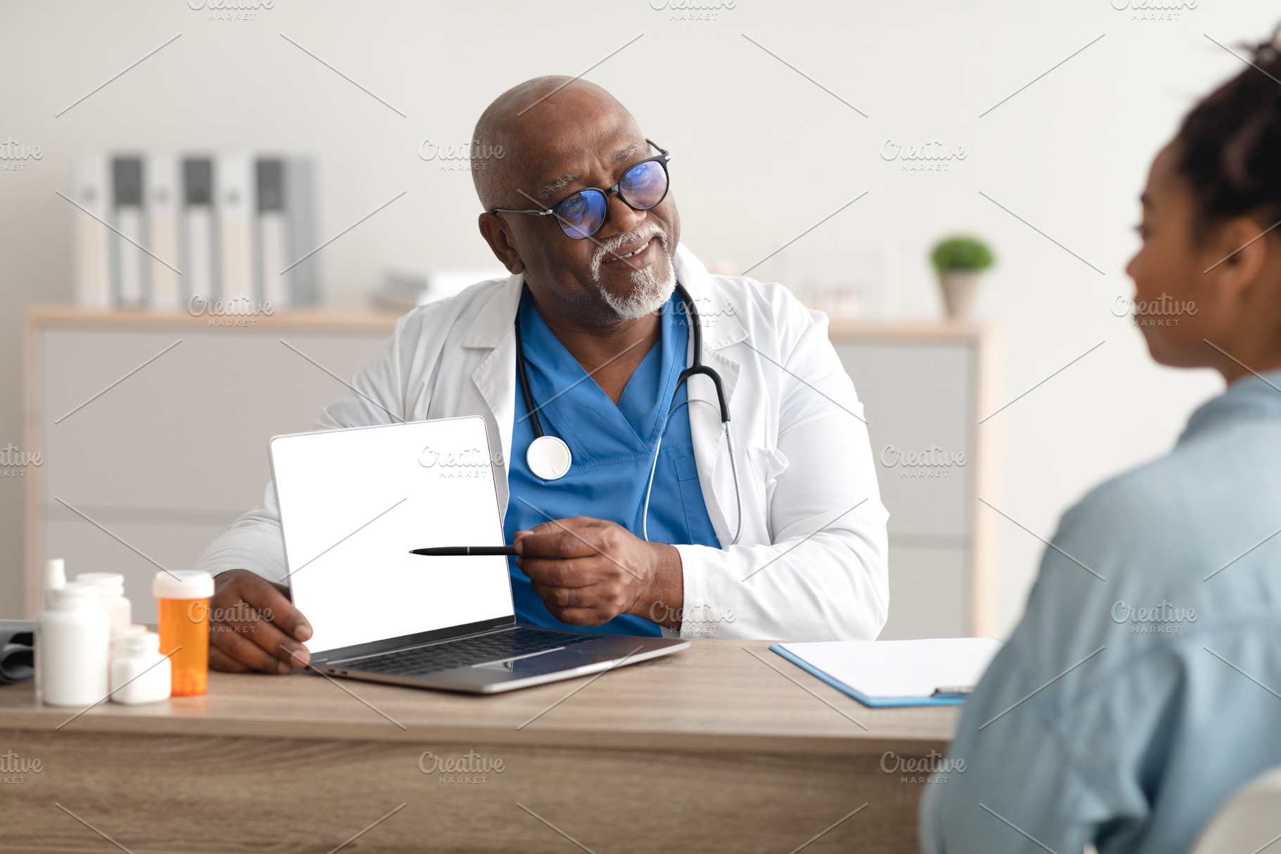 Experienced black doctor explaining treatment plan to female patient, a Photo by Prostock-Studio